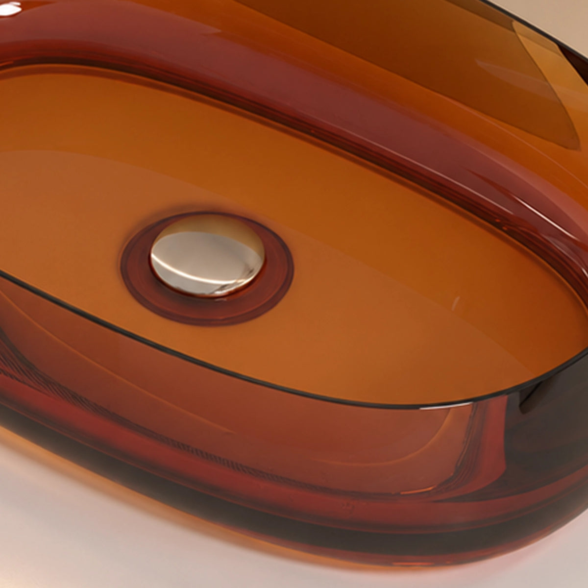 Close-up of the glossy orange-red resin basin and drain opening on an oval vessel bathroom sink