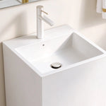 Close-up of the square basin, single faucet hole, and drain on a white freestanding bathroom sink