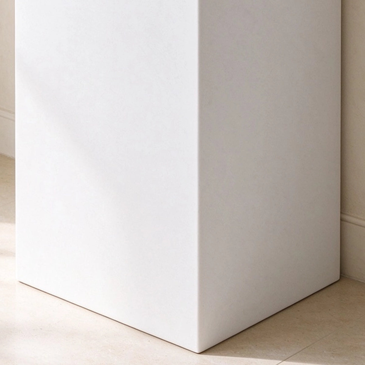 Close-up of the white freestanding pedestal base and clean floor-mounted design