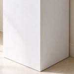 Close-up of the white freestanding pedestal base and clean floor-mounted design