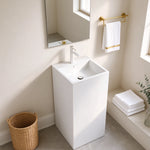 White square-basin pedestal bathroom sink shown in a bright bathroom corner