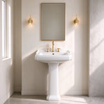 White ceramic rectangular pedestal bathroom sink with three-hole faucet in a classic bathroom setting