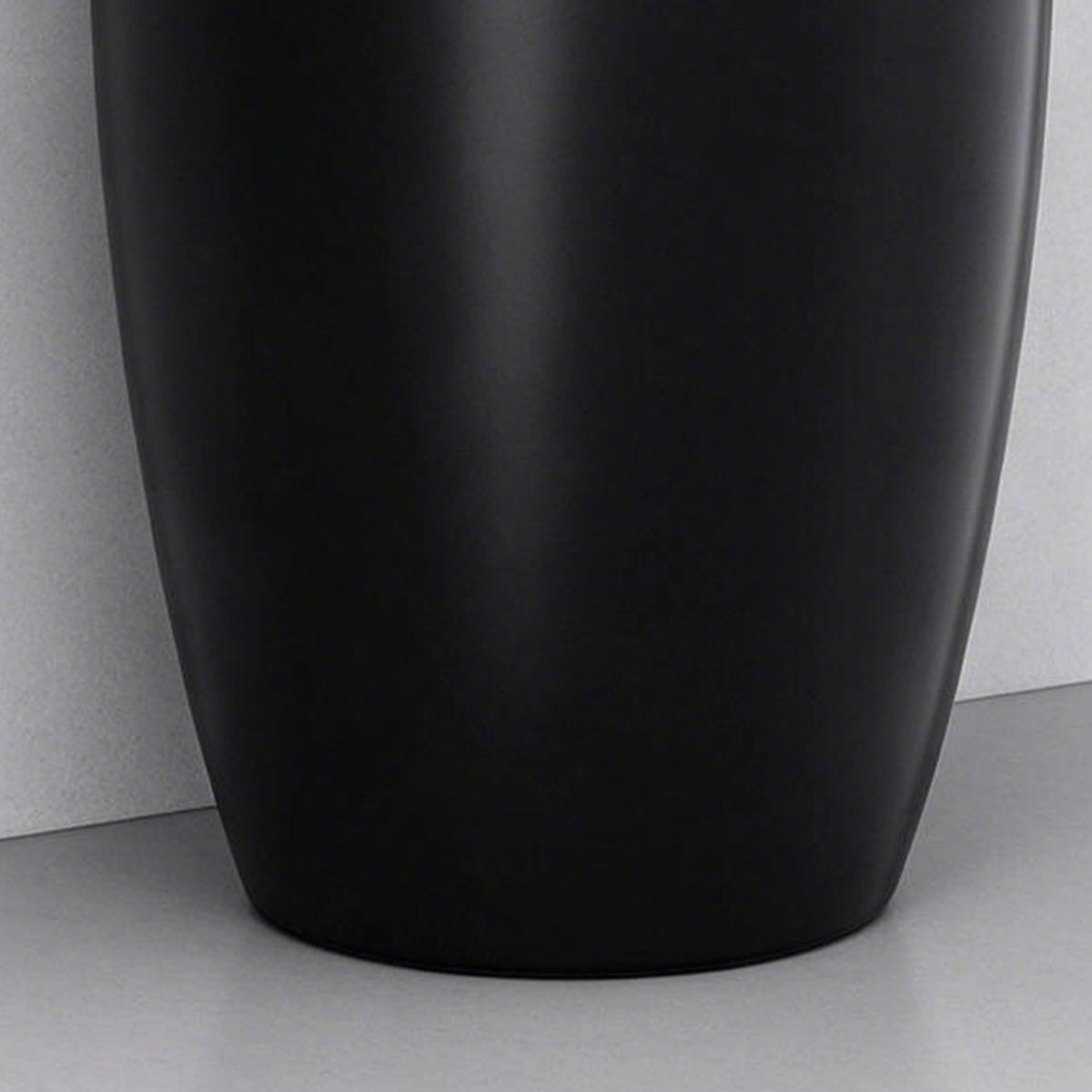 Close-up of the black ceramic pedestal bathroom sink base with a smooth curved design