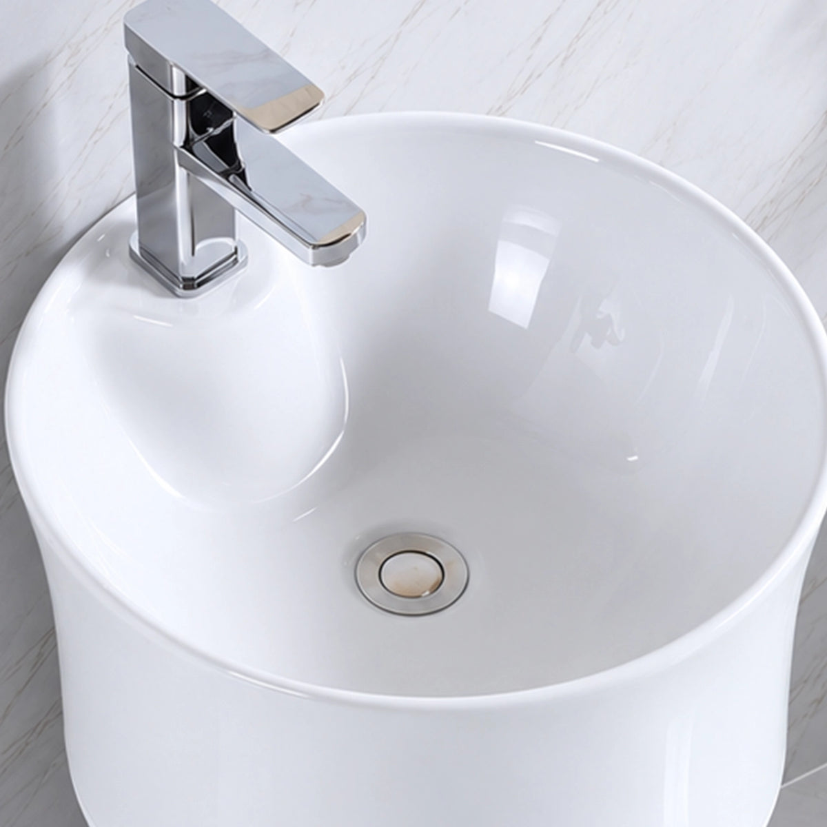 Close-up of white ceramic oval bathroom sink basin and faucet hole