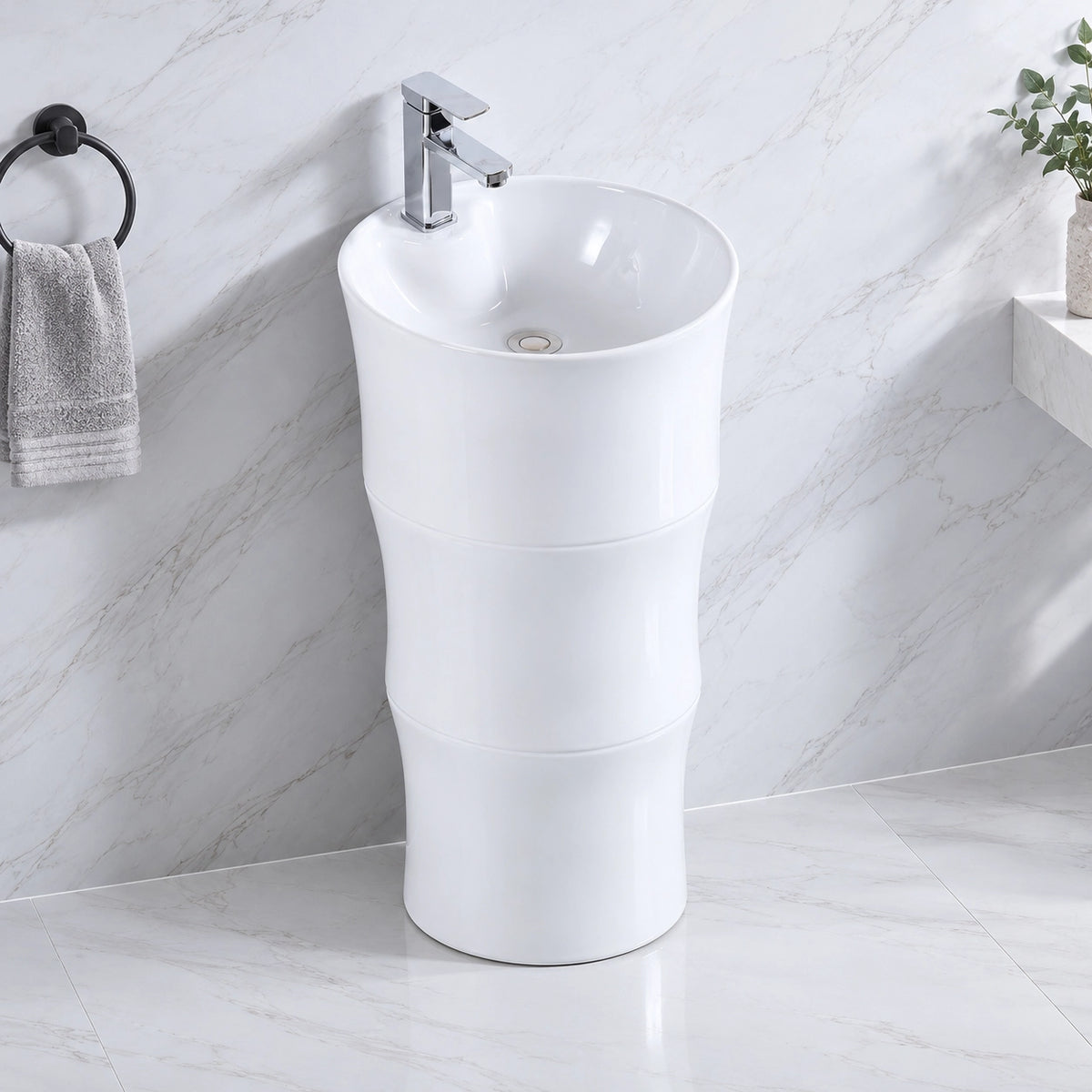 White ceramic oval pedestal bathroom sink with single-handle faucet in a modern bathroom