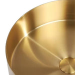 Close-up of the gold stainless steel round vessel sink basin and drain