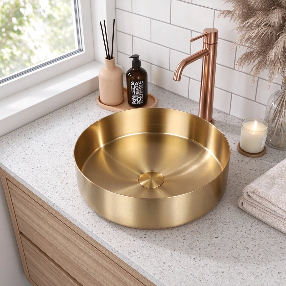 Gold stainless steel round vessel bathroom sink on a modern bathroom countertop