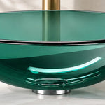 Close-up of the green tempered glass round vessel bathroom sink, highlighting the transparent glass basin and drain area.