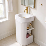 White freestanding bathroom sink with round basin and vertical fluted cabinet design