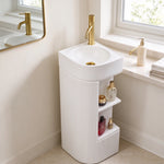 White round pedestal bathroom sink with a freestanding fluted pedestal base, open storage shelves, and gold-tone faucet.