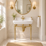 White rectangular console bathroom sink with gold-tone supports in an elegant bathroom setting