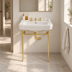 White rectangular console bathroom sink with gold-tone support frame and three-hole faucet in a modern bathroom setting