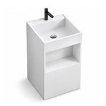 White engineered stone square freestanding bathroom sink with an integrated basin, black single-hole faucet, and open storage shelf.