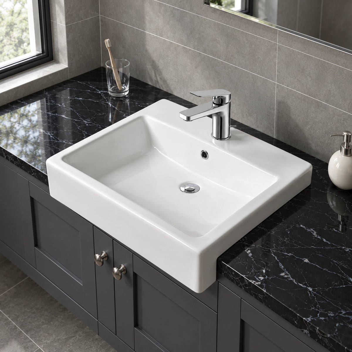 White ceramic semi-recessed bathroom sink with a rectangular basin, single-hole faucet, and integrated overflow on a dark vanity countertop.