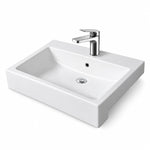White ceramic semi-recessed bathroom sink with rectangular basin, single faucet hole, and integrated overflow.