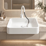 White ceramic semi-recessed bathroom sink with rounded rectangular basin and white horizontal pull-out faucet in a modern vanity.